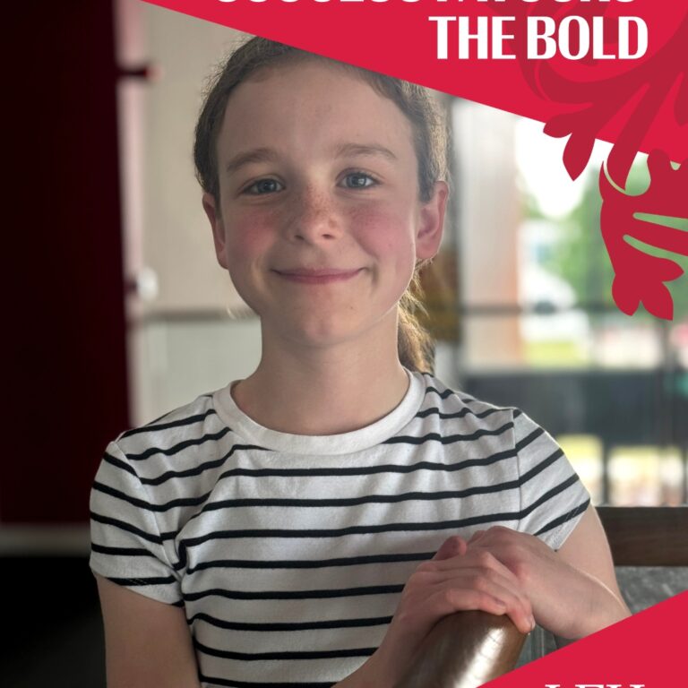 Smiling girl in a striped shirt indoors, with a pink diagonal banner reading 'SUCCESS FAVOURS THE BOLD' and a LEH logo in the corner.